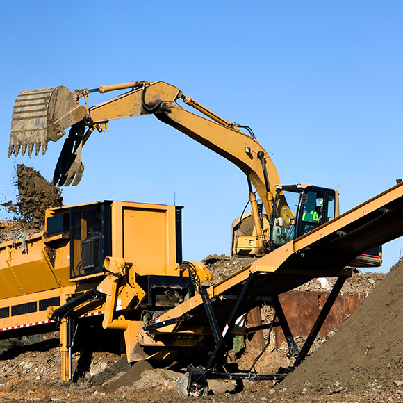 Banner_Products_Commercial-Insurance_02-Waste-&-Recycling-Risks Digger in operation to promote Greenfield Risk Solutions Insurance Brokers - Commercial Insurance - Waste and recycling risks