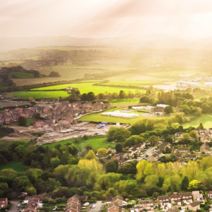 Green landscape surrounding many homes to promote Greenfield Risk Solutions - Property Insurance