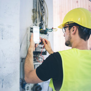 Electrician working on meter to promote Greenfield Risk Solutions - Specialist Risk and Contractors Insurance - Electricians