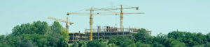 Cranes towering over construction site to promote Greenfield Risk Solutions