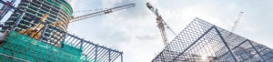 Cranes towering over office buildings to promote Greenfield Risk Solutions Insurance Brokers - Construction and Contractors Insurance