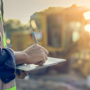 Construction worker holding clipboard on site to promote Greenfield Risk Solutions Insurance Brokers - Construction and Contractors Insurance - Contract Works