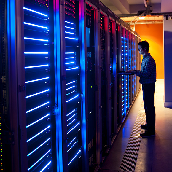 Male worker checking on extensive operating systems to promote Greenfield Risk Solutions Insurance Brokers - IT and Technology - IT and Software Professionals Insurance