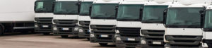 Parked fleet of lorries lined up to promote Greenfield Risk Solutions Insurance Brokers - Motor Fleet Insurance