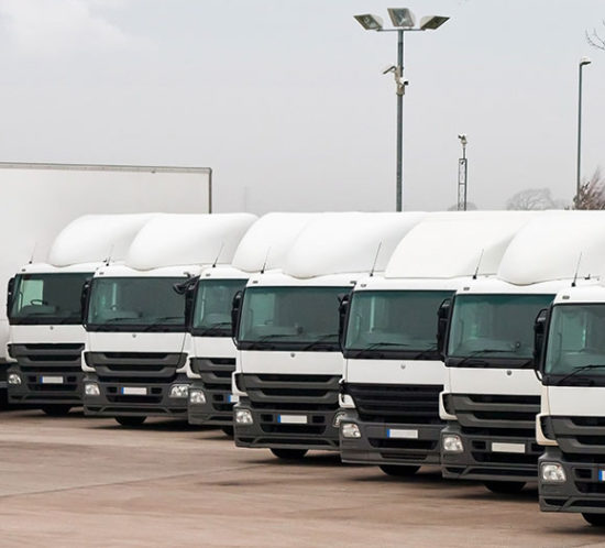 Parked fleet of lorries lined up to promote Greenfield Risk Solutions Insurance Brokers - Motor Fleet Insurance
