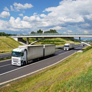 Multiple HGVs driving on motorway to promote Greenfield Risk Solutions Insurance Brokers - Motor Fleet Insurance