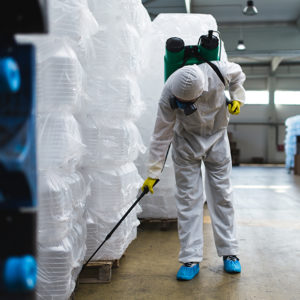 Pest controller in action in a factory to promote Greenfield Risk Solutions - Specialist Risk and Contractors Insurance - Pest Control