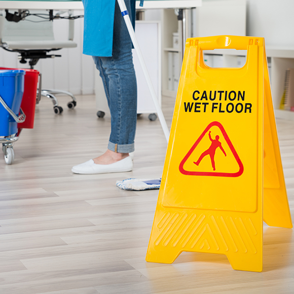 Wet floor sign to promote Greenfield Risk Solutions - Tradesman Insurance - Cleaning contractors