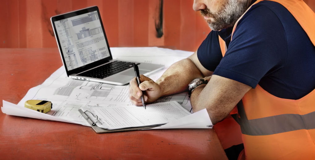 Construction worker working on paperwork to promote Greenfield Risk Solutions Insurance Brokers