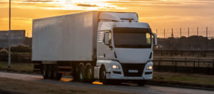 HGV dirving at sunset to promote Greenfield Risk Solutions Insurance Brokers - Motor Fleet Insurance