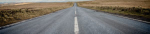 A vast expanse of open road surrounded by fields to promote Greenfield Risk Solutions Insurance Brokers- Driver Training Insurance