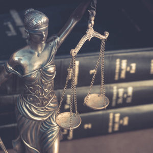 Statue of lady justice holding scales to promote Greenfield Risk Solutions Insurance Brokers - Financial Lines - Crime Insurance