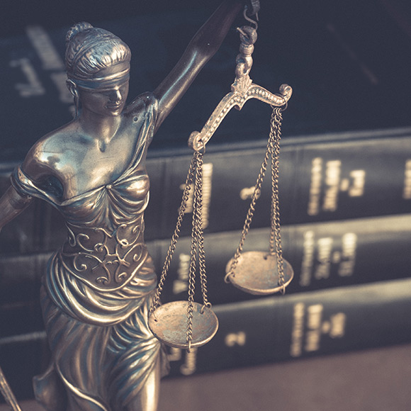 Statue of lady justice holding scales to promote Greenfield Risk Solutions Insurance Brokers - Financial Lines - Crime Insurance