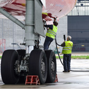 Two men working by side of plane to promote Greenfield Risk Solutions Insurance Brokers - High Risk Complex Liability - Airside Insurance