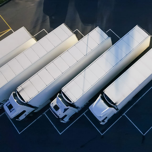 Lined up parked lorries to promote Greenfield Risk Solutions Insurance Brokers - Driver Training Insurance