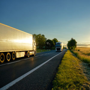 HGV on the road at sunrise to promote Greenfield Risk Solutions Insurance Brokers Training Driver Scheme