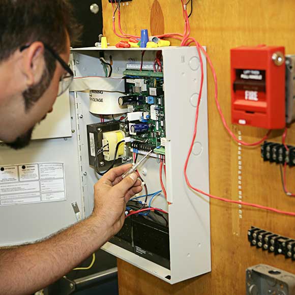 Electrician working on meter to promote Greenfield Risk Solutions Insurance Brokers - Construction and Contractor Insurance - Fire