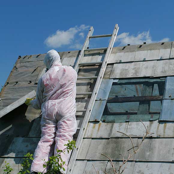 Contractor treating roof for asbestos to promote Greenfield Risk Solutions Insurance Brokers - Specialist Risk and Contractor Insurance - Asbestos and Waste Contractors